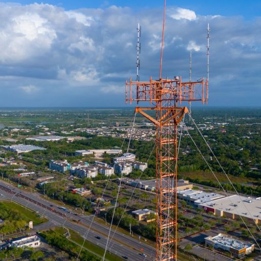 Tall radio tower overlooking a cityscape, illustrating the Avenal managed access test