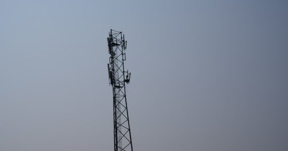 A tall tower with a cell phone on top of it, illustrating jamming in a Tijuana prison
