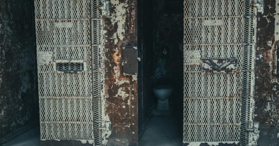 Abandoned prison cells with open doors, illustrating a borrowed phone ending in punishment