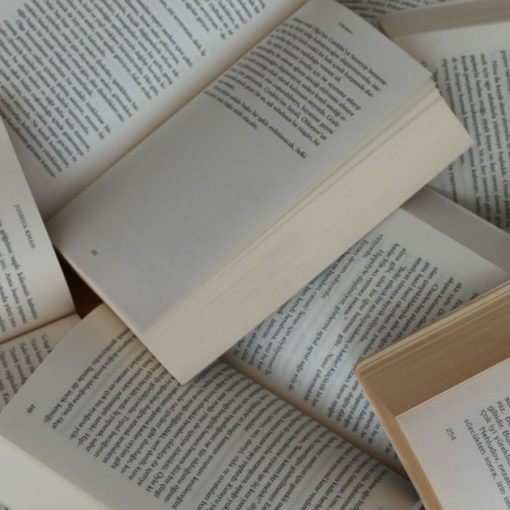 Pile of open paperback books, illustrating California dropping a phone smuggling law