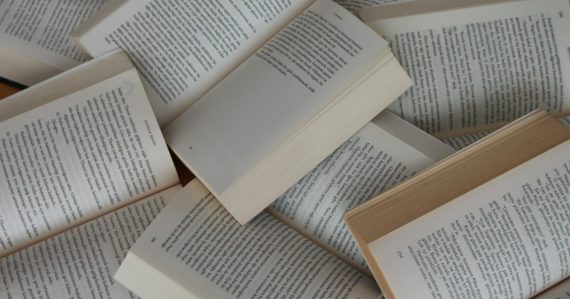 Pile of open paperback books, illustrating California dropping a phone smuggling law