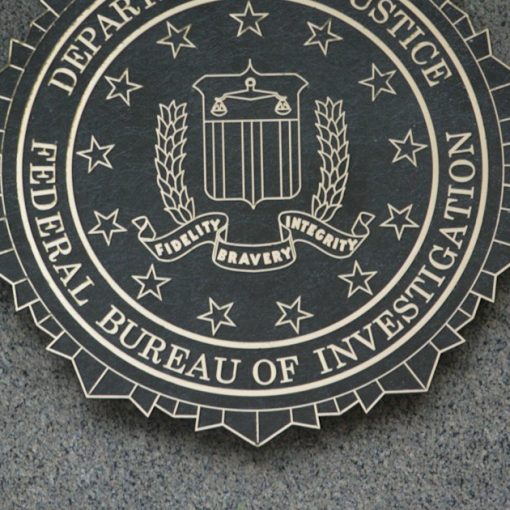 The seal of the department of justice on a wall, illustrating the FBI report on phones as contraband