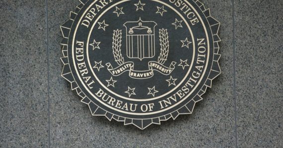The seal of the department of justice on a wall, illustrating the FBI report on phones as contraband