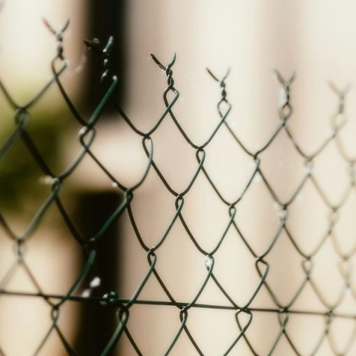 A close up of a chain link fence, illustrating prisons battling phone smuggling