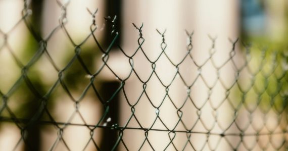 A close up of a chain link fence, illustrating prisons battling phone smuggling