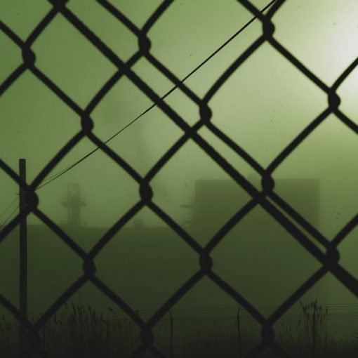 Black metal fence with chain link fence, illustrating supply and demand for contraband phones