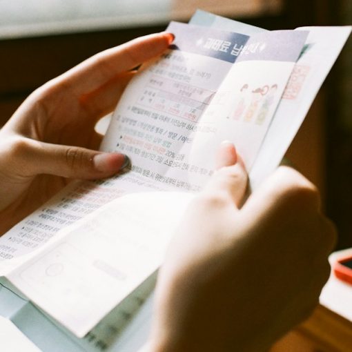 Person holding white printer paper, illustrating California's contraband phone bill advancing