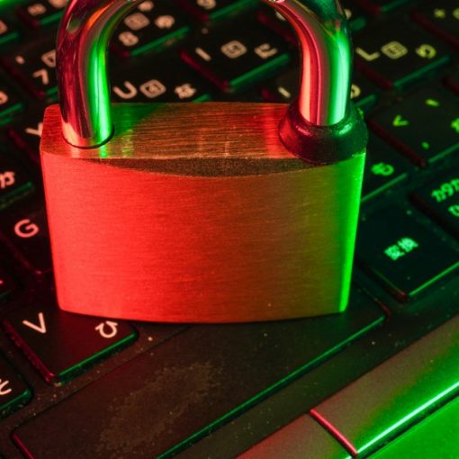 Red padlock on black computer keyboard, illustrating encrypted VoIP on contraband phones
