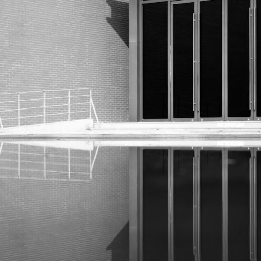 A black and white photo of a jail cell, illustrating guards drawn into contraband smuggling