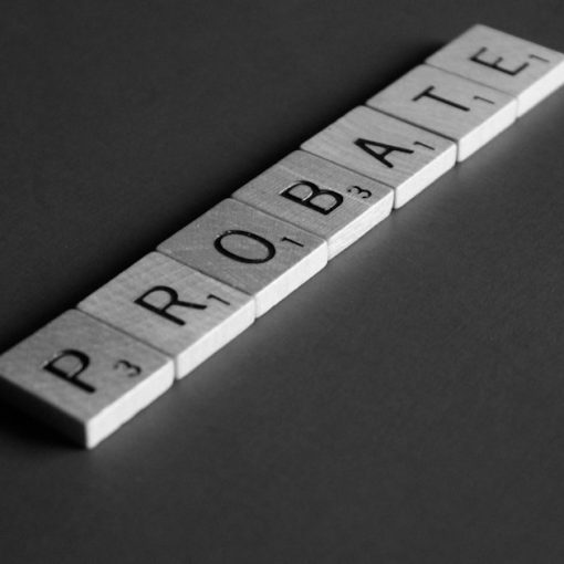 Photo of scrabble toy on gray surface, illustrating an officer on probation for smuggling