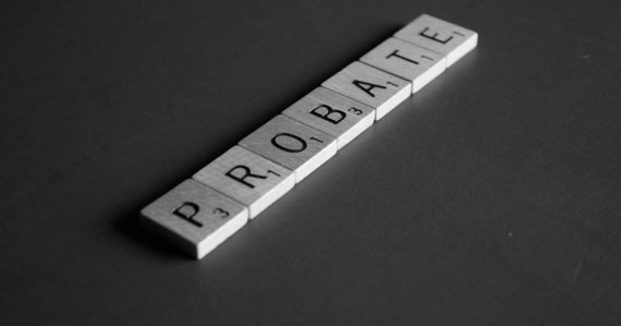 Photo of scrabble toy on gray surface, illustrating an officer on probation for smuggling