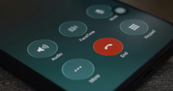 A smartphone screen displaying a call interface with circular buttons, illustrating jail calls and domestic violence victims