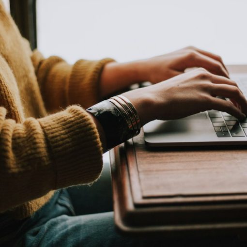 Person sitting front of laptop, illustrating email access for federal inmates