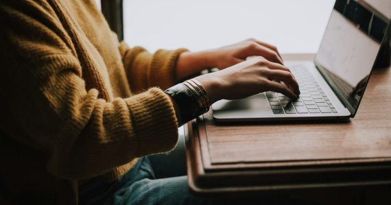 Person sitting front of laptop, illustrating email access for federal inmates