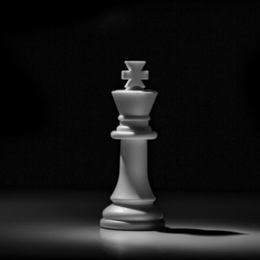 A white chess king piece against a dark background, illustrating GTL and prison managed access