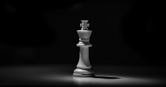 A white chess king piece against a dark background, illustrating GTL and prison managed access