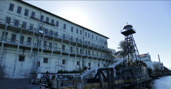 Alcatraz island prison building with guard tower, illustrating a guard facing smuggling charges