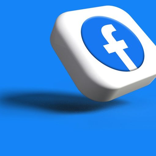 A white dice with a blue facebook logo on it, illustrating inmates harassing victims online