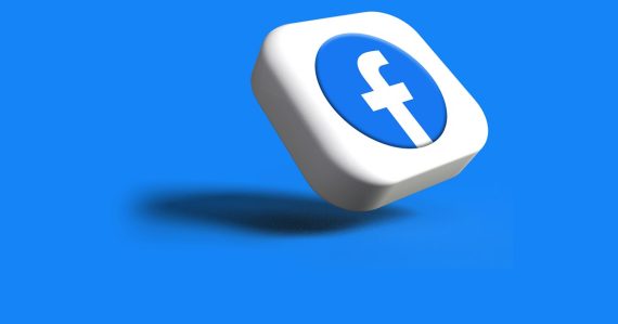 A white dice with a blue facebook logo on it, illustrating inmates harassing victims online