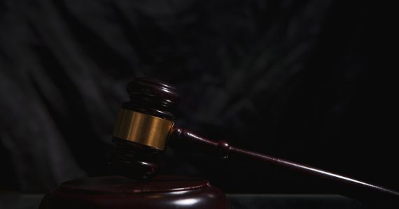 A wooden gavel rests on a dark surface, illustrating harsher penalties for phone smuggling