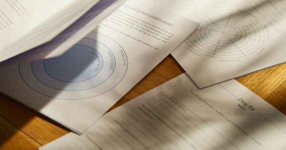 A close up of papers on a wooden table, illustrating BOP crowding and phone access