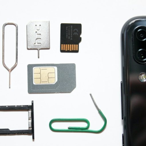 A cell phone with a sim card attached to it, illustrating inmate phone card revenue