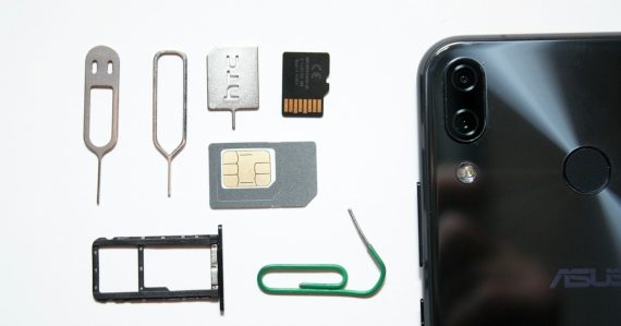 A cell phone with a sim card attached to it, illustrating inmate phone card revenue
