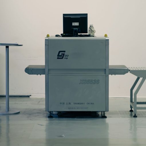 X-ray scanner with laptop in a clean room, illustrating staff intercepting smuggled phones
