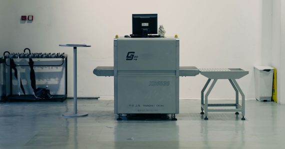 X-ray scanner with laptop in a clean room, illustrating staff intercepting smuggled phones