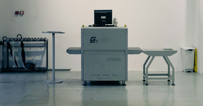 X-ray scanner with laptop in a clean room, illustrating staff intercepting smuggled phones