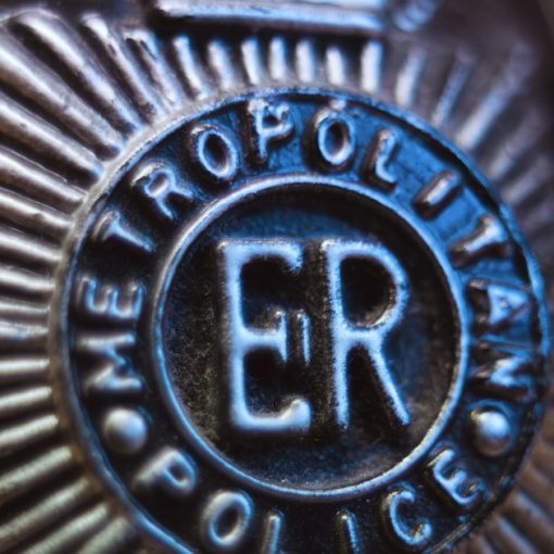 Close-up of a metropolitan police badge, illustrating sheriffs defending jail call commissions