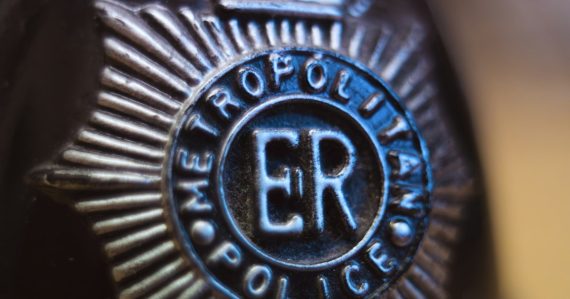 Close-up of a metropolitan police badge, illustrating sheriffs defending jail call commissions