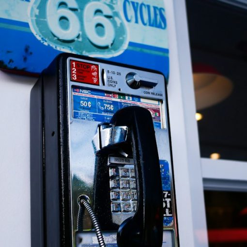 Classic payphone attached to a building wall, illustrating jail phone revenue for counties