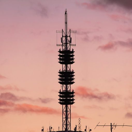 Transmission tower during golden hour, illustrating jail warders under scrutiny over jamming