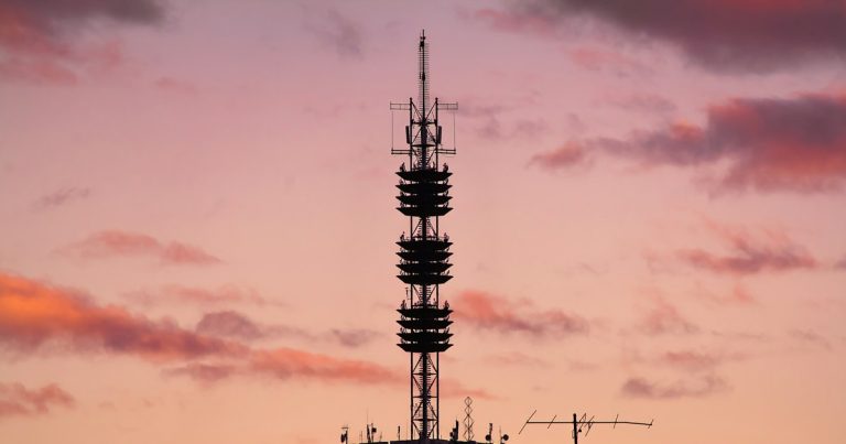 Transmission tower during golden hour, illustrating jail warders under scrutiny over jamming