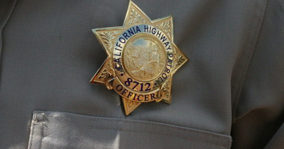 A close up of a police officer's uniform, illustrating a jailer charged with smuggling to a gang member