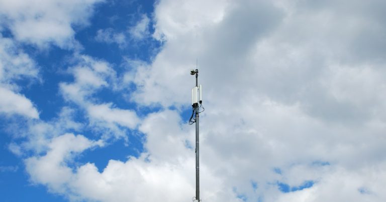 A very tall antenna on a cloudy day, illustrating jammers at South Asia's largest jail