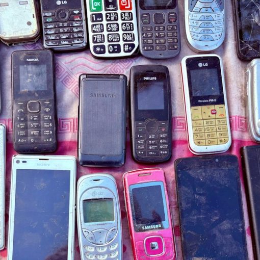 A collection of various old mobile phones and devices, illustrating mobile phones found in Liverpool prisons