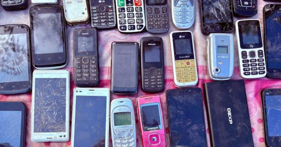 A collection of various old mobile phones and devices, illustrating mobile phones found in Liverpool prisons