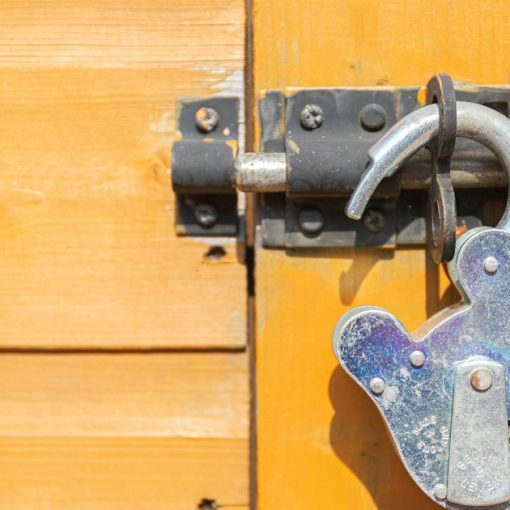 Brown wooden door with padlock, illustrating Mississippi's penalties for phone possession