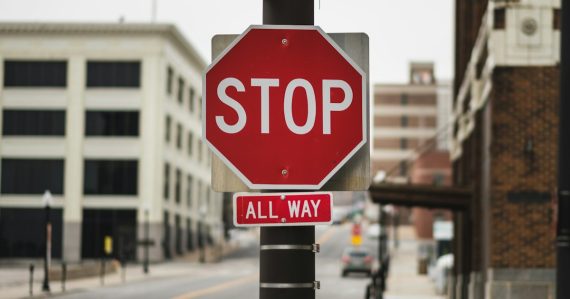 Red stop sign, illustrating California halting managed access jamming
