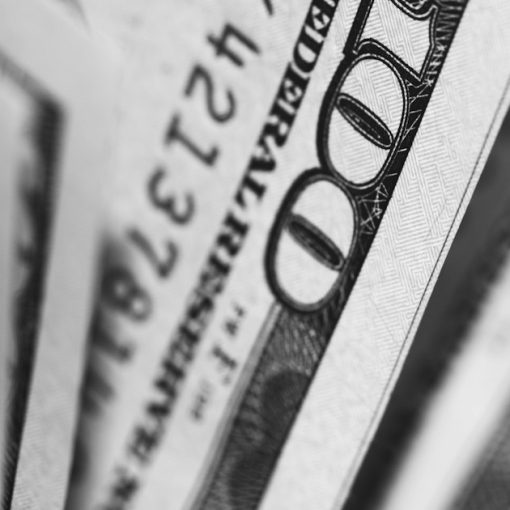 Closeup photo of 100 US dollar banknotes, illustrating a costly managed access failure