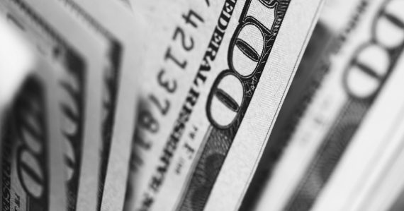 Closeup photo of 100 US dollar banknotes, illustrating a costly managed access failure