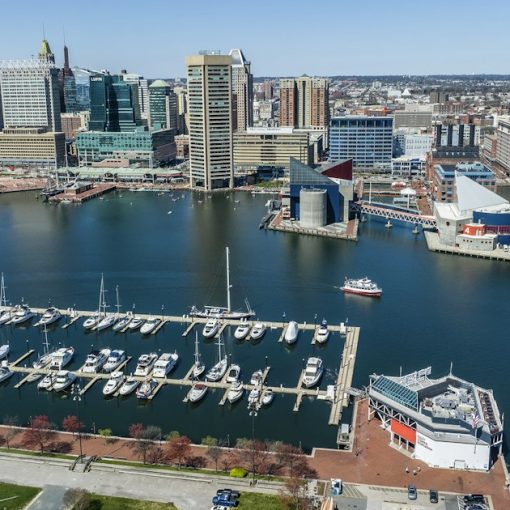 A marina with boats docked and a city in the background, illustrating federal funds for Maryland's phone removal