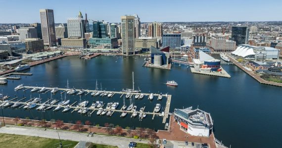 A marina with boats docked and a city in the background, illustrating federal funds for Maryland's phone removal
