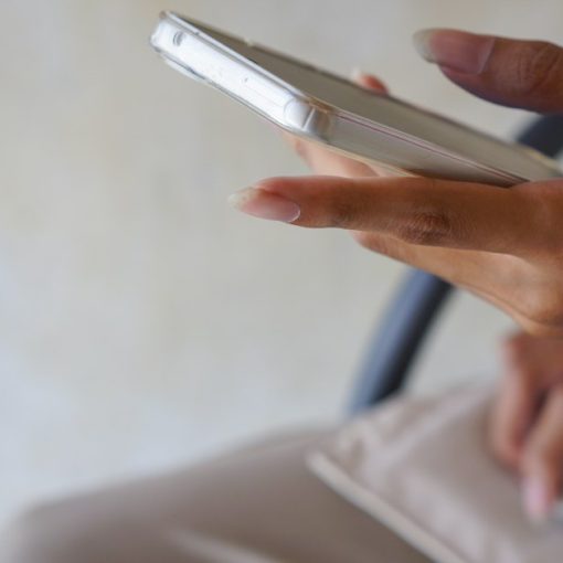 A close up of a person holding a cell phone, illustrating prisoners outwitting phone blocking