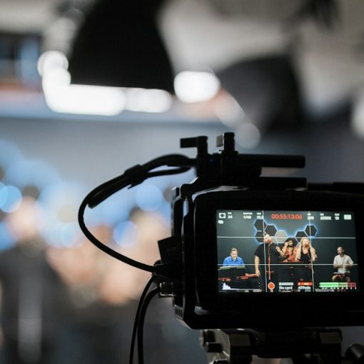 A professional video camera recording a group in a studio, illustrating a New Jersey phone investigation video