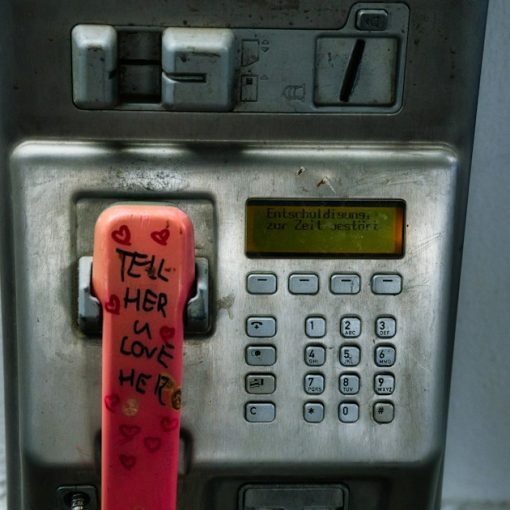 An old pay phone with graffiti on it, illustrating Michigan using phone revenue for jammers