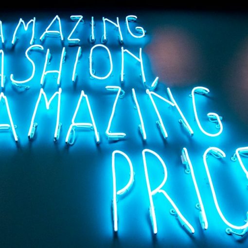 Blue neon price signs, illustrating Michigan's prison phone rate jump