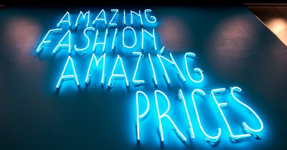 Blue neon price signs, illustrating Michigan's prison phone rate jump
